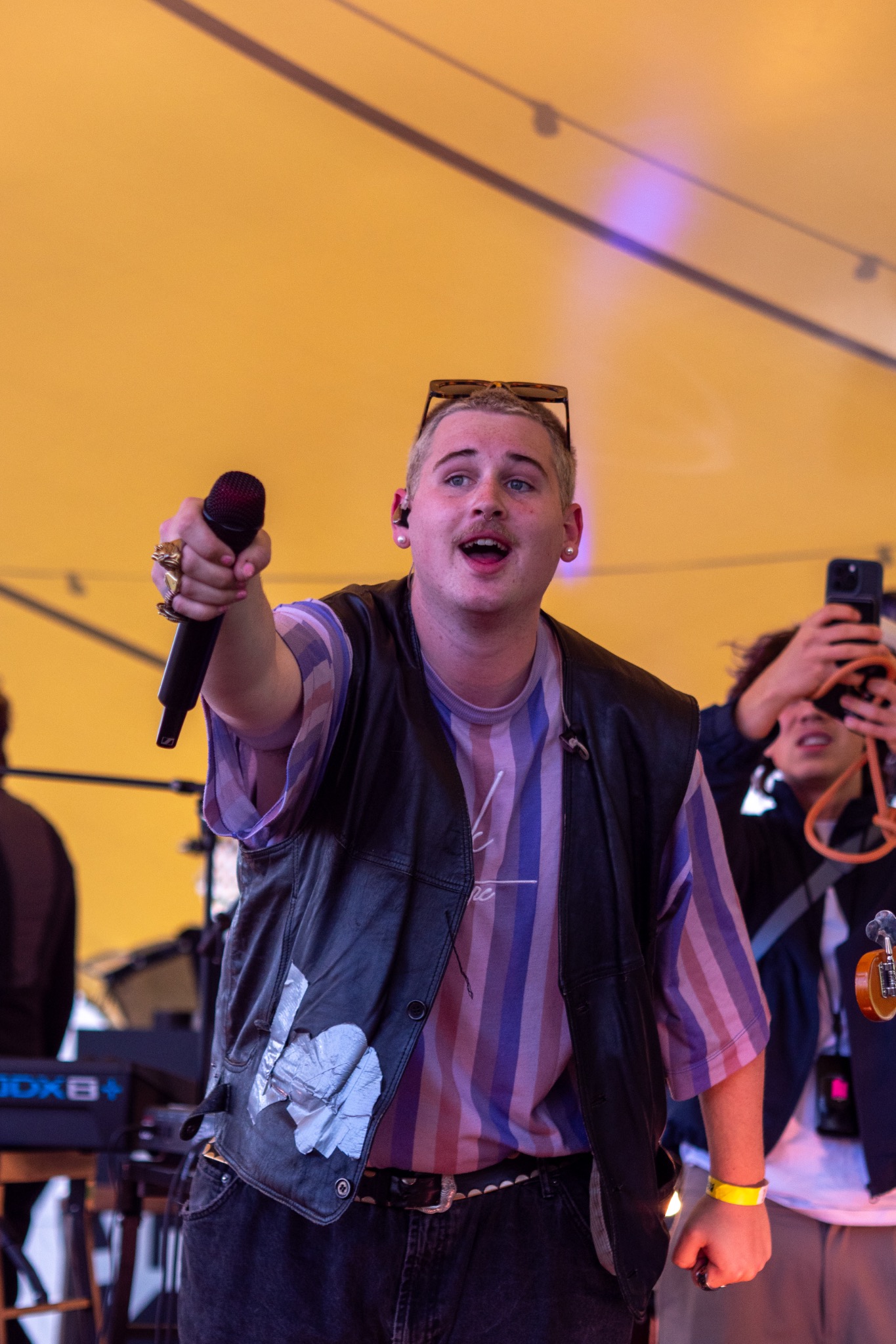 Singer reaching toward the audience with a microphone.